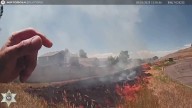 Deputy grabs fire extinguisher to help stop grass fire approaching neighborhood