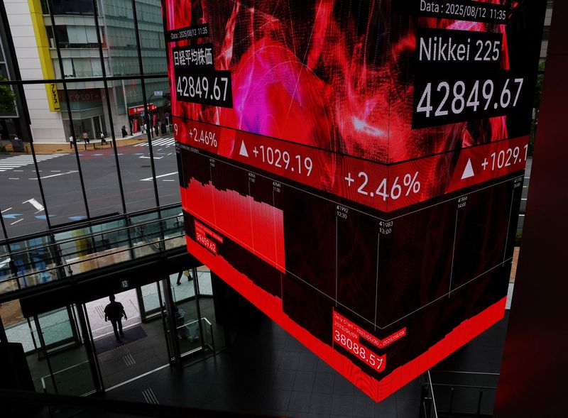 Japan's Nikkei races to record high, SoftBank leads tech surge