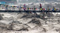 Building collapses into overflowing river during India floods