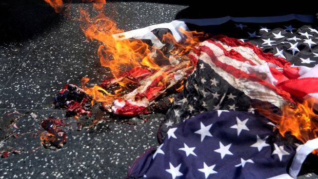 Trump signs order banning flag-burning — a right protected by the U.S. Constitution