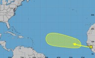 Hurricane center says system moving into Atlantic with potential