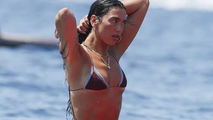 Dua Lipa looks incredible as she strips down to her bikini for paddleboard yoga session on Ibiza holiday