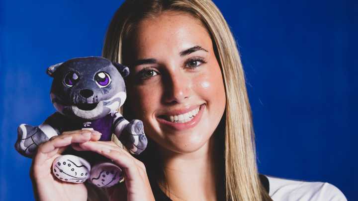 Kansas State commit Reese Resmer on her Willie The Wildcat plush doll