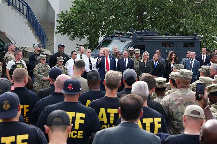 Trump visits police, troops in DC after suggesting he would patrol streets