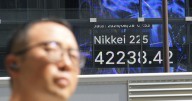 Asian shares post modest gains after Wall Street nears more records