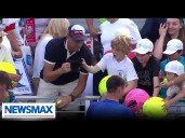 Man takes hat from kid at US Open