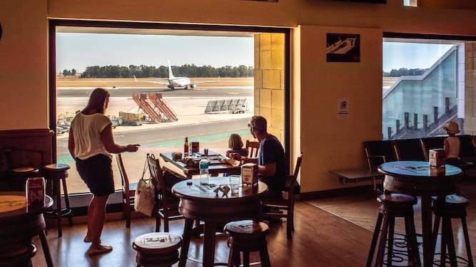 Family of maniacs having sit-down meal in departures