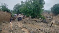 Flash floods triggered by heavy rains kill at least 49 people in northwestern Pakistan