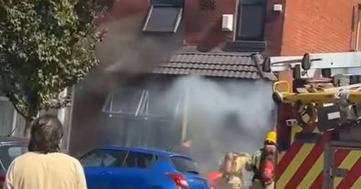 Road closed off and emergency services called after house erupts into flames