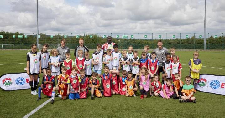 Emile Heskey surprises young footy fans at summer camp