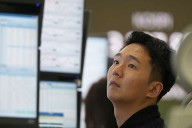 Asian shares are mixed after stocks add a bit to their records on Wall Street