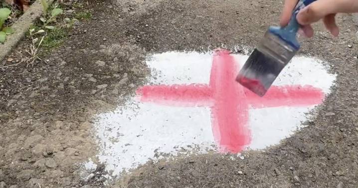 Man 'cracks code' to getting potholes fixed - painting them with St George cross