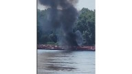 Two die when helicopter strikes powerlines and crashes into a barge on the Mississippi River