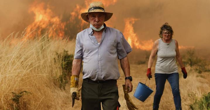 Photos of the wildfires in Europe displacing thousands as residents join efforts to fight the flames