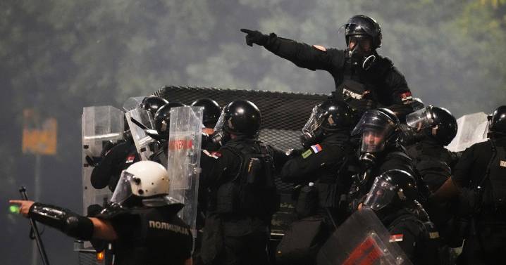 Tensions soar in Serbia as angry protesters clash with police, set fire to party offices
