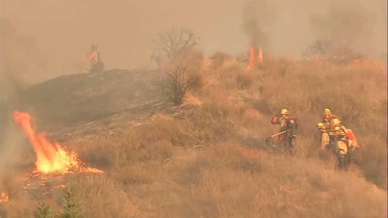 Fast-growing brush fire forces thousands to evacuate north of Los Angeles
