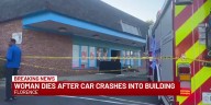 Woman dies after car crashes into building