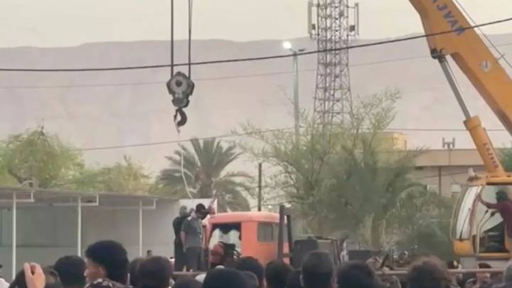 Haunting moment Iran hangs murderer from crane in front of ghoulish crowd including kids in latest grim public execution