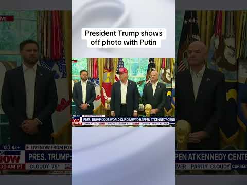 President Trump shows off photo with Putin
