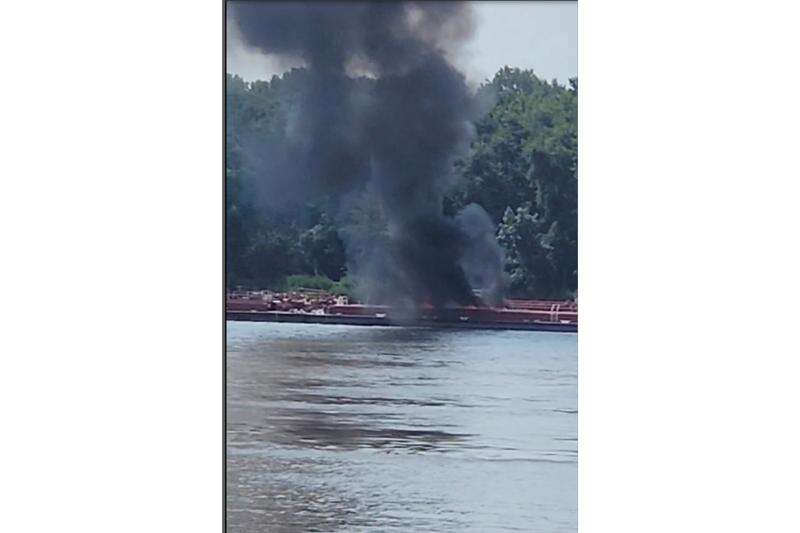 Two die when helicopter strikes powerlines and crashes into a barge on the Mississippi River