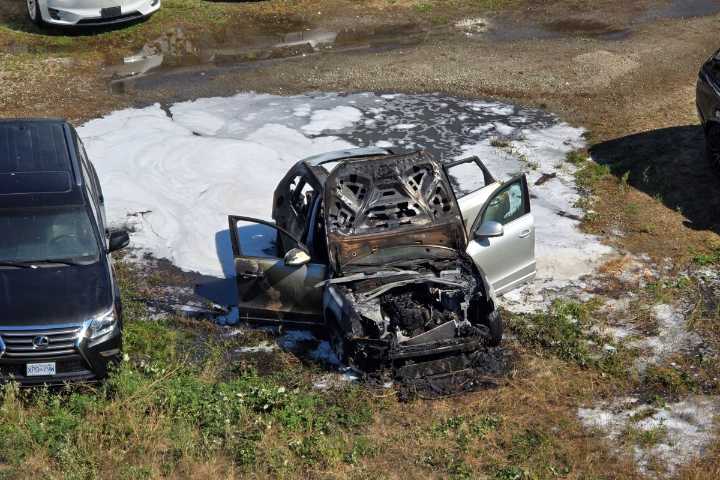 Car fire in fenced Richmond BC parking lot on weekend