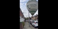 Hot air balloon lands on residential street in dramatic video