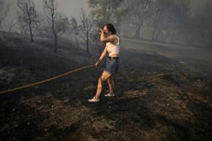 Spain suffers third wildfire death, Greece beats back flames