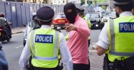 Three arrested at asylum hotel protest 'with kids present' as officer punched