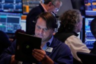 Wall Street hovers near records as markets take in earnings ahead of Powell speech Friday
