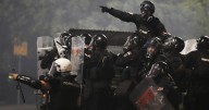 Tensions soar in Serbia as angry protesters clash with police, set fire to party offices