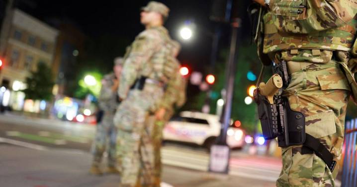 National Guard troops in Washington, DC, begin carrying weapons