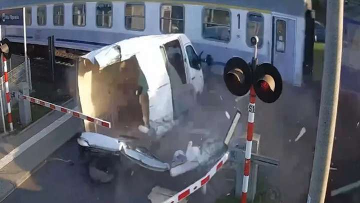 Watch moment idiot driver gets van SMASHED by train after trying to skip barriers at level crossing