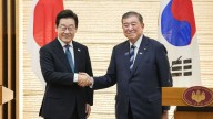 At historic summit between Japan and South Korea, Trump’s presence looms large