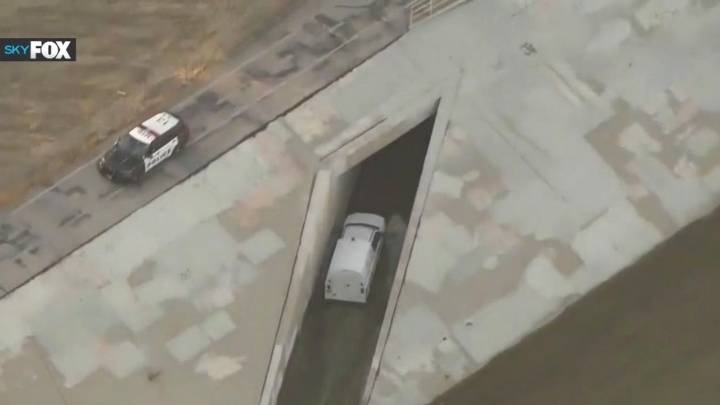 Van pulls into storm drain mid