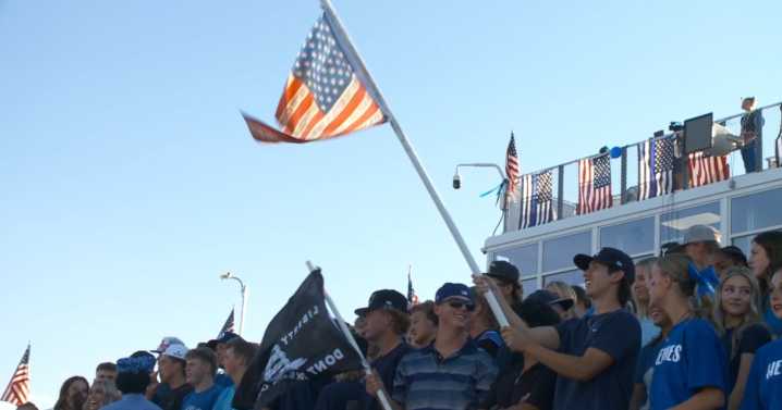 Community dresses blue for first football game since officers killed