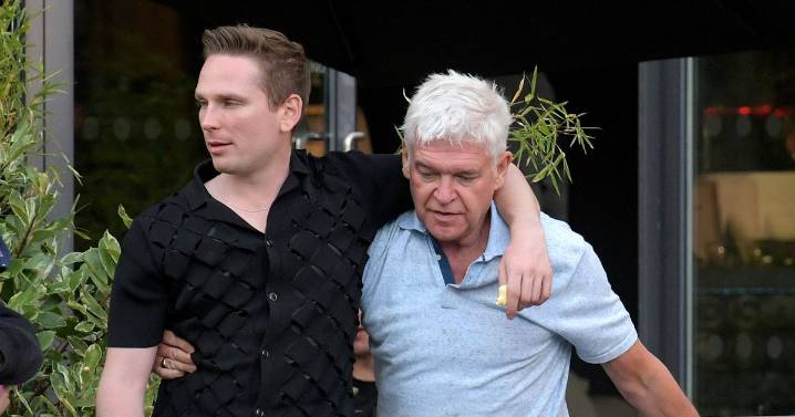 Phillip Schofield clings onto male companion as he leaves bar after failed TV comeback