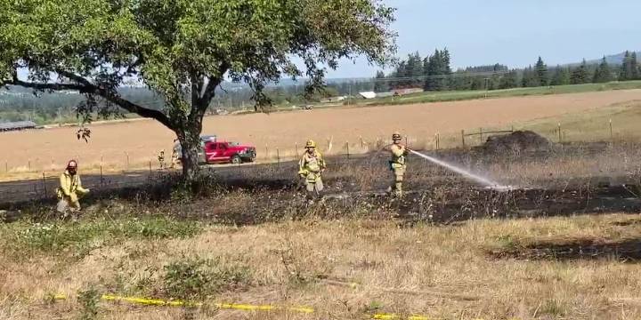 Crews stop spread of brush fire in hay field near Sherwood