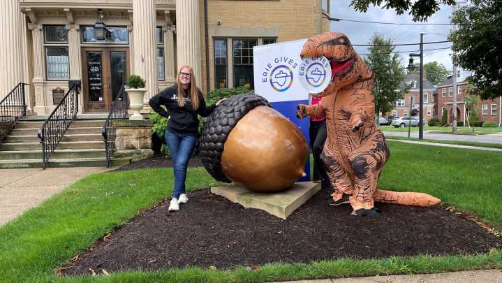 Brian Johannson, CEO of Erie City Mission, wears dinosaur suit in Erie