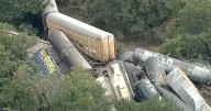 Train derailment horror as 35 cars carrying 'hazardous material' crash together sparking fire