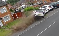 Driver crashes and flips vehicle onto residential street narrowly missing homes