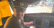 Half the World Away...Bonehead poses in the cockpit as Oasis ready for Canada gigs