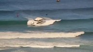 Yacht-sized passenger boat runs aground in high surf off Hawaii beach