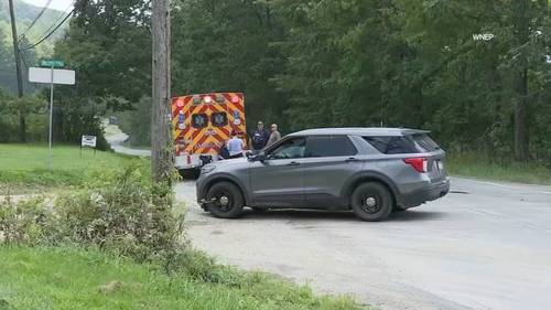 Woman killed by neighbor before 2 responding Pennsylvania state police troopers wounded in ambush shooting