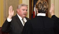 Pueblo city, county leaders call on embattled coroner Cotter to resign