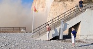 Heart-stopping moment cliff face caves in as horrified tourists watch on