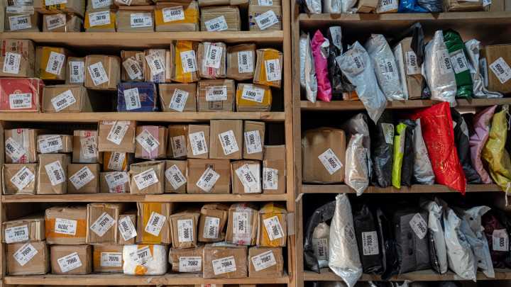 Why are global postal services cutting off package delivery to the US?