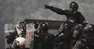 Tensions soar in Serbia as angry protesters clash with police, set fire to party offices