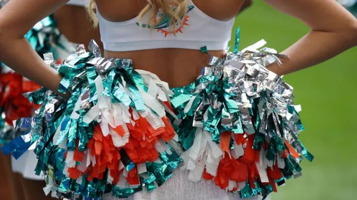 NFL cheerleader arches back to flaunt flawless figure in cheeky uniform