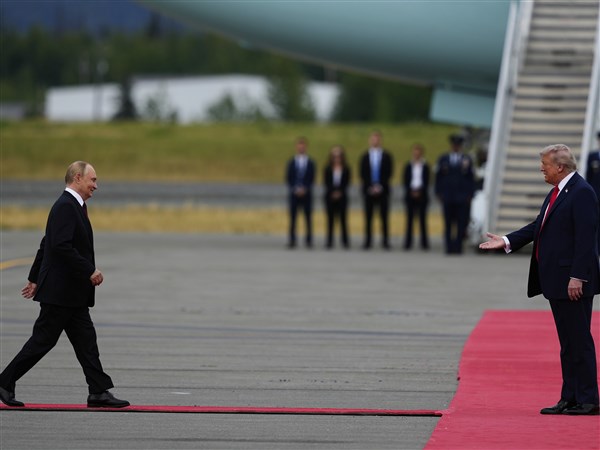 Trump and Putin share handshake in Alaska, a warm greeting belying the bloodshed in Ukraine