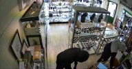 Horrifying moment armed thugs tie up shopkeeper in £50,000 jewellery raid